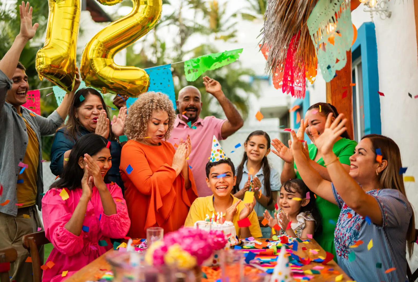 Family celebrating child's birthday with cake.