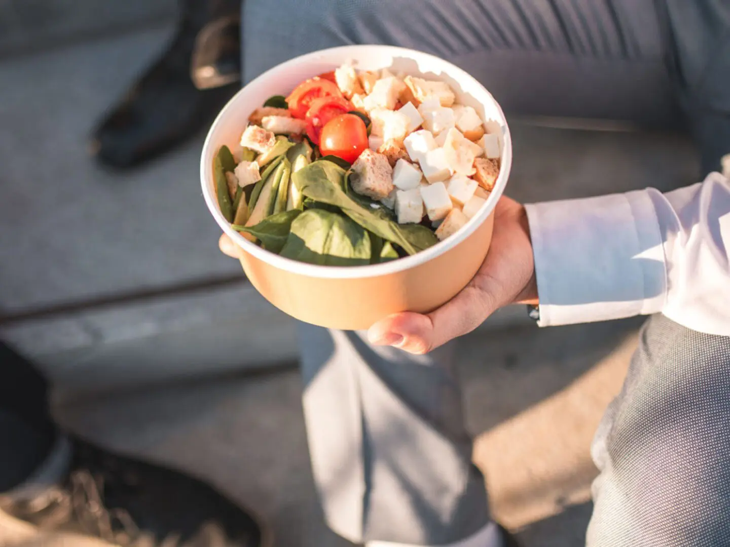 Salad bowl with spinach, tomatoes, and croutons.