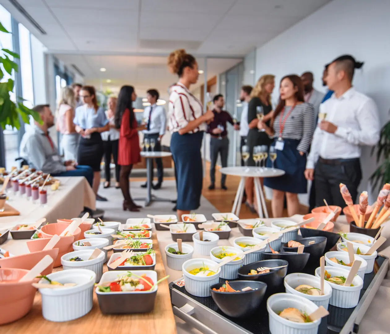 Office gathering with food and drinks.