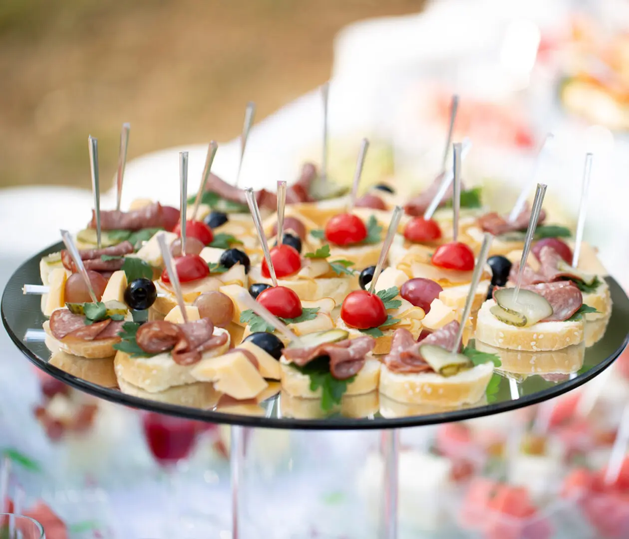 Assorted appetizers on a platter with skewers.